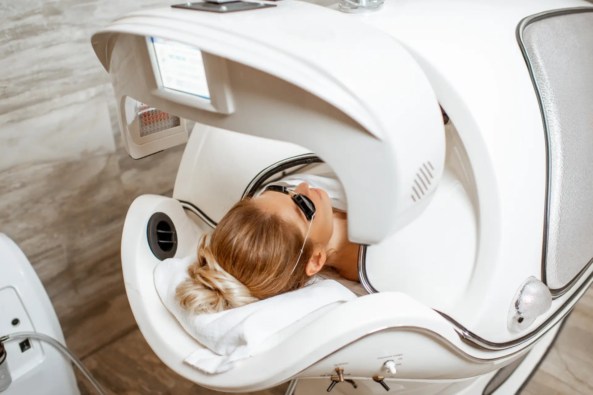 A practitioner performing a laser treatment in a calm Winnipeg clinic